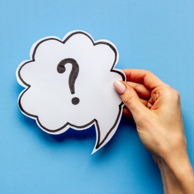 Question mark on speech bubble in hands. FAQ or search information.